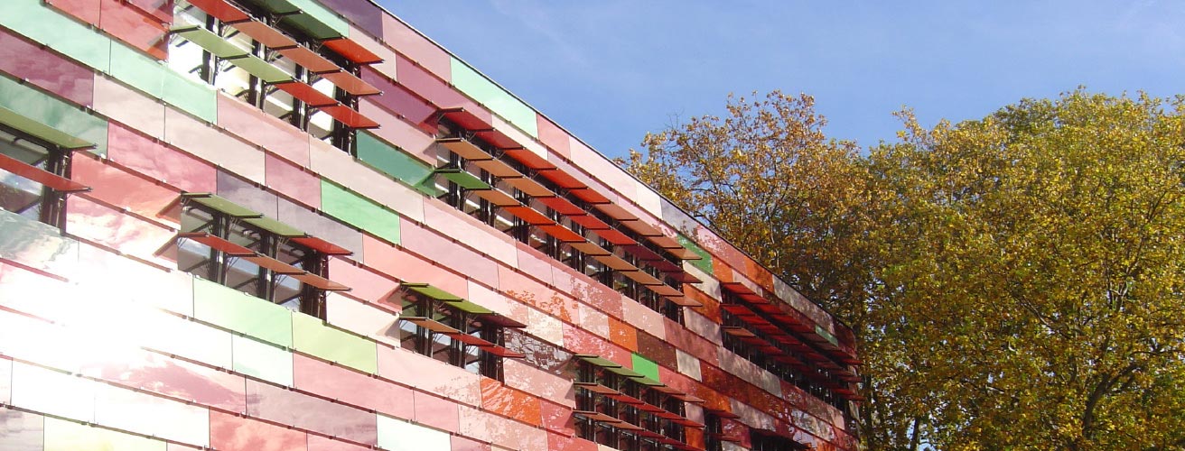 Coloured screen-printed glass “scale” façade with opening louvres